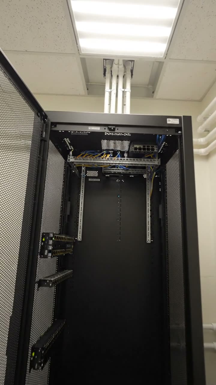A comms room cabinet with the door open