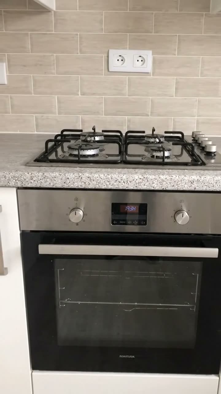 A built-in oven and gas hob photographed square on