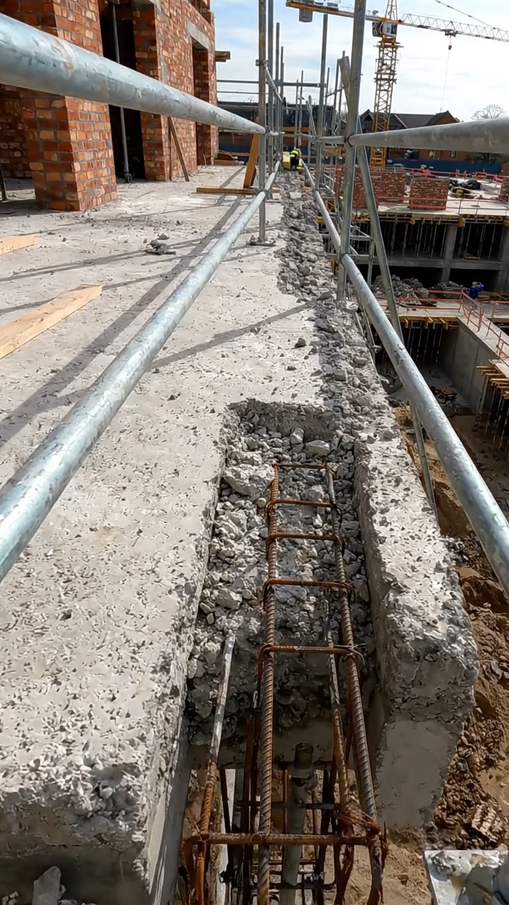 Tube guardrails along the edge of a concrete floor slab
