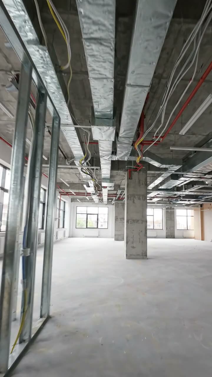 An office floor with metal stud partitions up and the ceiling open
